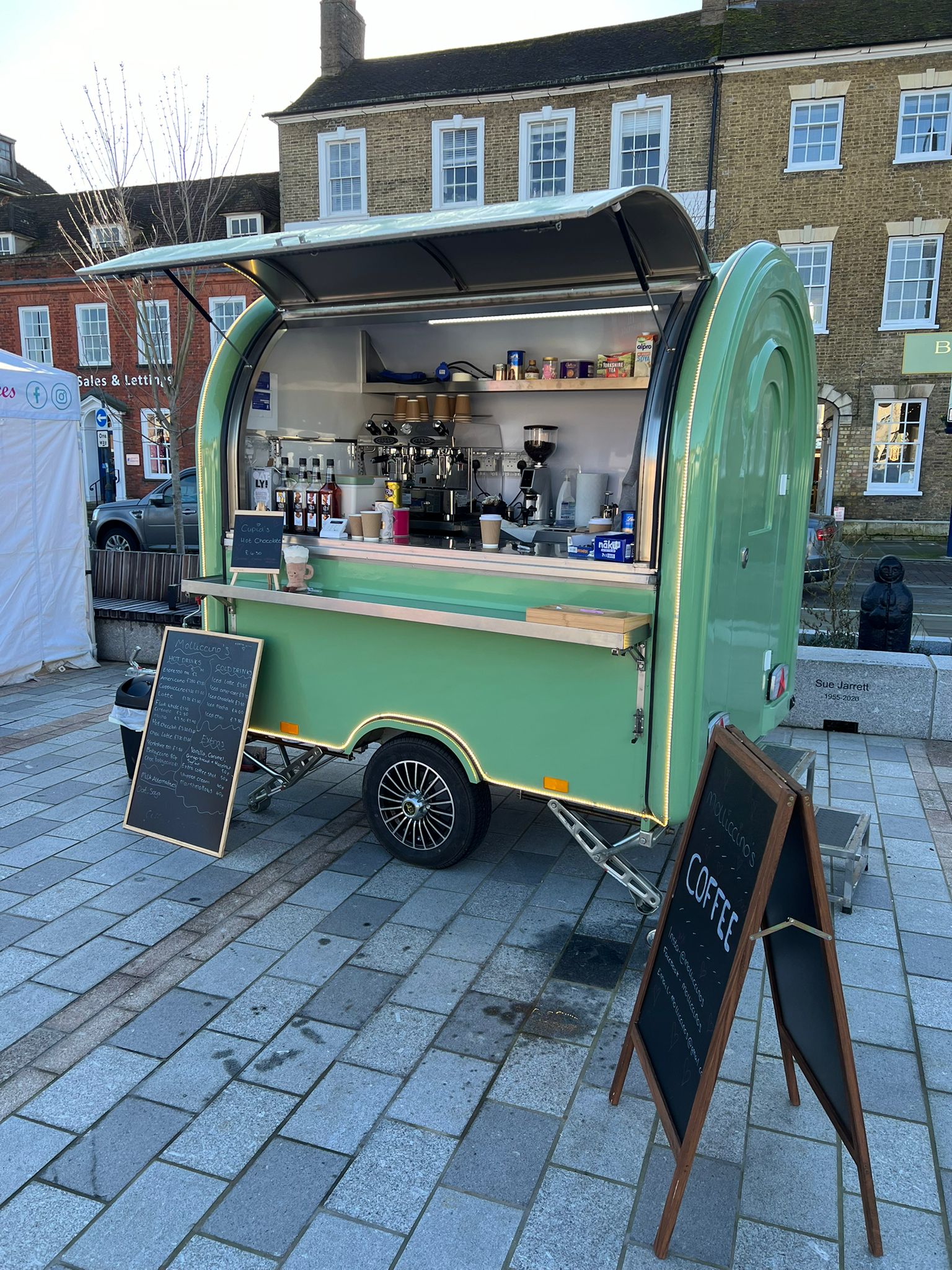 Molliccino's coffee trailer set up in a town square market